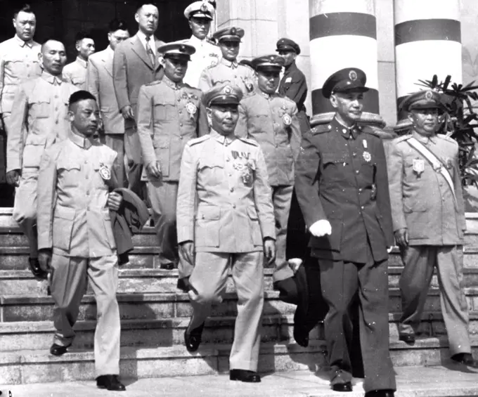 China Kai-Shek And Aides - This recent picture of Generalissom Chiang Kai-Shek (foreground) shows the Nationalist China president leading group of his officers down steps of Ministry of National Defense ***** in Taipei, Formosa, Occasion for the picture received in United States Sunday, was not explained in U.S. Army caption accompanying it. Officers were not identified. February 9, 1953. (Photo by AP Wirephoto).