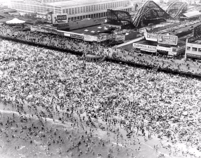 Sun And Lotion Are Popular Here - Here is an aerial view of Coney Island as Sunday temperature hit a scorching 86.4 and almost a million people jammed the popular bathing spot seeking relief. June 25, 1951. (Photo by AP Wirephoto).