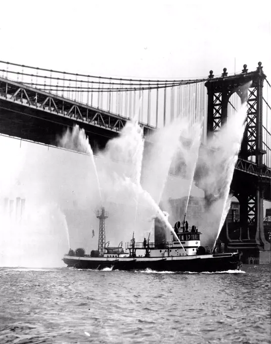 Manhattan Bridge Is Not On Fire -- Despite this alarming indication to the contrary, there is no reason to assume that the famous Brooklyn Bridge is on fire and requiring the attentions of fireboats. The boys are merely submitting the New York Fire Department's fireboat "John P. Mitchell" to official tests following its overhauling and the installation of a new high-pressure pumping system. The boat can now deliver 9,700 gallons of water a minute. It is estimated that her efficiency was increased by 33% by the replacement of her equipment. March 29, 1930.