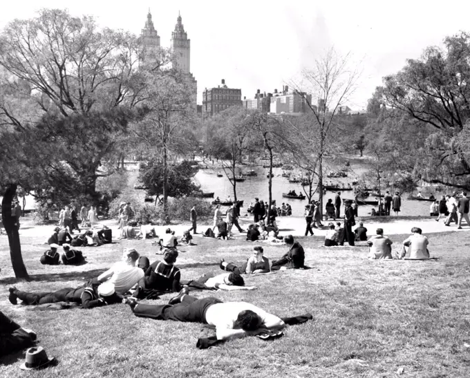 ***** park when yesterday's sunshine ***** invited a large crowd to the park, ***** and visitors to the city. ***** some took to the lake in hired boats, ***** are shown here content with ***** or lying on the grass. New York's 500-acre Central Park. . .  a refuge from life on an island. December 05, 1947.
