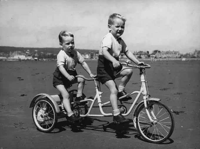 A Tricycle Made For TwoSauabbles between four-year-old David Stacey and his three-year-old brother Geoffrey when they both wanted to ride their single tricycle at the some time have now been happily ended by their father.The family funds would not allow the boys to have a tricycle each so Mr. Stacey did a nout little engineering job and converted the machine to a tandem. Now David and Geoffrey, who live at Weston-super-are, are happy as long as they both want to ride the same way. July 30, 1954. 