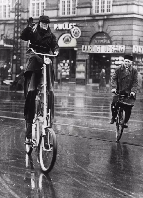 A Long Ride on a Long Bicycle -- Mr. Akil Danielson, is riding from Stockholm to Monte Carlo, on the route of the Monte Carlo Rally, on a remarkably high bicycle and on stilts. Mr. Danileson passing through Copenhagen on his way south. January 28, 1935. (Photo by Sports & General Press Agency, Limited).