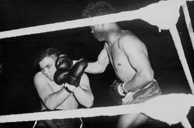 Dave Sands Wins In London -- Sands (right) lands a hard right to Villemain's head.Dave Sands, the Australian triple champion, defeated Robert Villemain, on points in their middleweight contest at Olympia, London, over ten rounds. July 05, 1949. (Photo by Sport & General Press Agency, Limited).