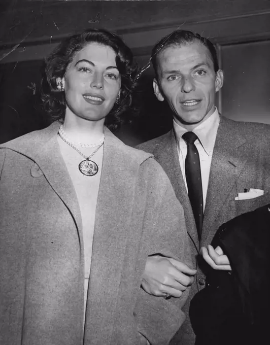 Date to see Vaudeville -- Singing star Frank Sinatra and actress Ava Gardner smile for photographers as they attended the two-a-day at the palace theatre tonight. waiting for his final Nevada decree from his wife, Nancy, Sinatra and the Glamorous actress are expected to wed when he's free. October 29, 1951. (Photo by Herbie Scharfman, International News Photos).