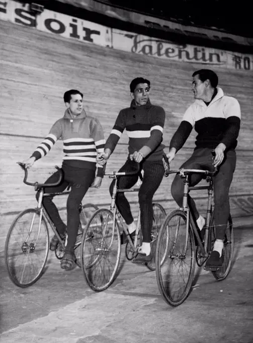 Six-Day Cycle Race In Paris -- Left to Right ; Alfred Strom of Australia; Gerit Peters of Haarlem, Holland, and Armin Von Buren of Zurich, Switzerland, make a leisurely turn around the Velodrome D'hiver, Mar. 18 in the six day cycle race in Paris, France.Australian cyclist Alf Strom (left) takes a leisurely turn around the Velodrome D'hiver during the recent six-day in Paris. Strom's companions are Gerit Peters (Holland) and Armin von Buren (Switzerland). March 20, 1950. (Photo by Associated Press Photo).