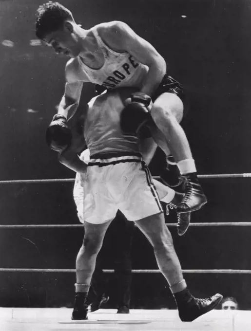 High Spot In International Bouts -- Stig Sjolin of Varanamo, Sweden. is hoisted to the shoulder of Richard Guerrero of Chicago, as the action became fast and furious tonight in l60»pound International Golden Gloves bout at Stadium tonight, Guerrero was awarded a decision. March 30, 1951. (Photo by AP Wirephoto).