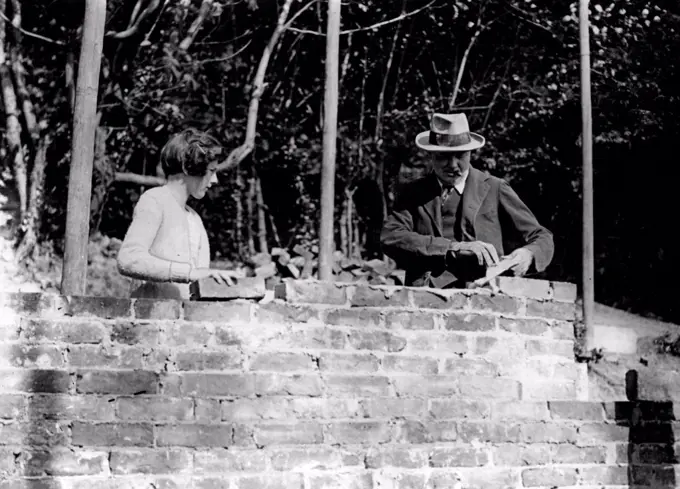 Mr. Churchill buildings his Own HouseGeneral view of Mr. Winston Churchill and his daughter at work bricklaying at Westeham, Kent.1936: Politics, landscape-painting, plumbing: he was at home with all of them. But for many years hobby was bricklaying. Here he is seen at work  on a garden wall at this home. September 03, 1928. (Photo by Topical Press).