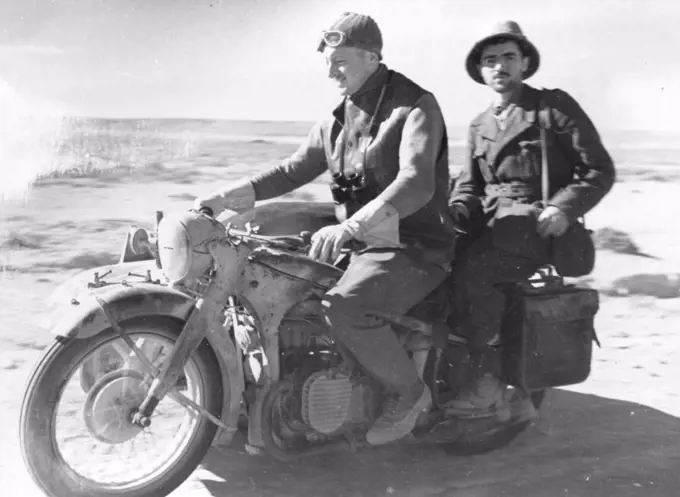 Italian prisoner being taken to headquarters by motor bike. March 01, 1942.