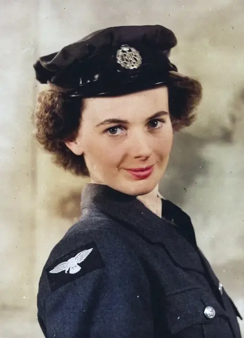 The W.A.A.F. Poster Girl - Miss Elizabeth Harvey photographed in W.A.A.F. uniform wearing hat. The W.A.A.F. Poster Girl is Elizabeth Harvey, who lives at ***** Latmore Avenue, Claygate, Surrey. She was chosen a week ago from six semi-finalists at a meeting which took place at the Air Ministry Whitehall, where the judges were Mr. William Dring, A.R.A., Air Chief Commandant Lady Welsh, Director of W.A.A.F., and Air Chief Marshal Sir Phillip Joubert de la Perte, K.C.B., C.I.C., D.S.O. Miss Harvey, who is tall and slim, is at present working for the Control Commission at Lubbeoke, Germany, was born in 1923 and was educated at St. Stephons College, Folkestone and Hillside Covont College, Farnborough, Kent. October 1, 1946. (Photo by British Official Photograph).