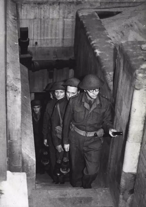 Vaults Searched By Home Guards -The search in progress. For the first time in history. Parliament provided its own armed guard for the traditional ceremony of searching the vaults before the opening of the session. A detachment of the Palace of Westminster Company of the Home Guard made the search in place of the beefeaters. January 13, 1944. (Photo by London News Agency Photos Ltd.). 