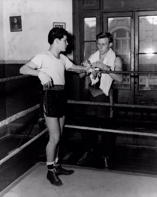 Charlie Dunn who meets Ray Fitton at the Stadium on Monday night in an earlier picture with worlds Champion Jimmy Carruthers. June 15, 1953. (Photo by Phil Ward Studios).