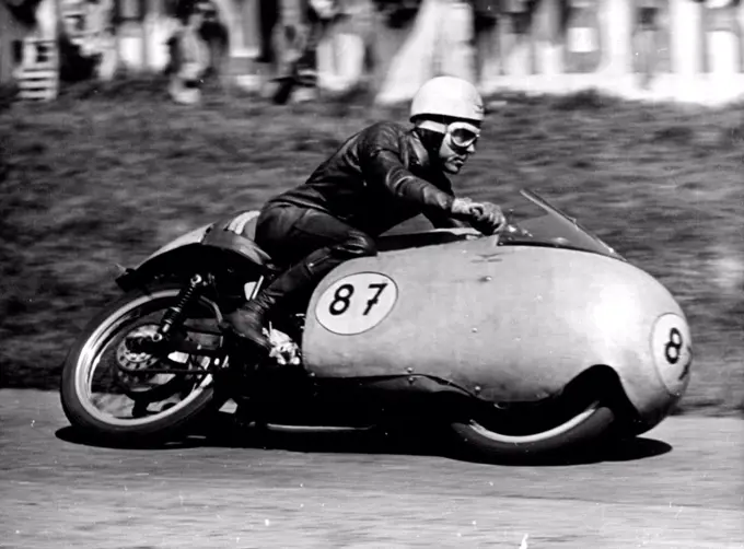 Duke Does It Again -- Australia's Ken Kavanagh at speed during the 350 CC Rave which he won on his Moto-Guzzi.Geoff Duke, Britains world 500 CC Motorcycle champion robe his 500 CC Gilera to Victory in the Rhine cup races at Hockenheim. Germany on Sunday.More than 120,000 fans saw him set up a lap record of 123.8. miles an hour, he covered the 20 laps in 47 minutes 12.5. seconds.Ken Kavanagh of Australia was second in this event and also won the 350 CC race on his Moto-Guzzi at 11.84 miles an Hour. May 10, 1955. (Photo by Paul Popper Photo, Paul Popper Ltd.).