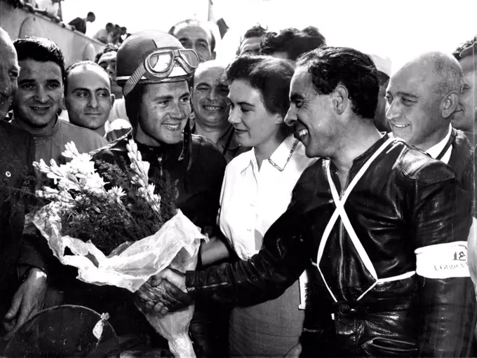 Duke Wins At Monza -- Ken Kavanagh (right) of Australia Congratulates Britain;s Geoffrey Duke, after the latter had won the 350 CC Motorcycle event of the grand Prix  Des Nations At Monza, Italy, September 9. Kavanagh was second, Both were riding Nortons.Britain's Geoffrey Duke, riding a Norton, won the 350 C.C. Motorcycle event in the grand Prix Des Nations At Monza, Italy, September 9. Second was Australian Ken Kavanagh, and Jack Brett, of Britain, was Third. Both the latter rode Norton. September 25, 1951. (Photo by Associated Press Photo).