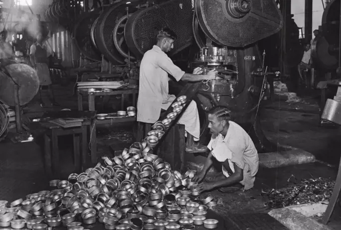 Steel And Metal Factory, Ishapore (near Calcutta). Parts for hurricane lanterns being manufactured in the factory.Products ranging from paper clips to road rollers are being made in India's Ordnance factories. From used cartridge cases they turn out brass tumblers and cycle bells in thousands. Lakhs of hurricane lanterns are fashioned by tools which made deadly weapons. Special steel which went into the making of munitions is now spared to make toy motor car springs. Tools for sewing machines, sections for electric switches, textile machinery components, Jute mill parts, locomotives and marine engine parts, machine tools, furniture and axles for carts are some of the articles manufactured for civilian consumers and Indian industries. February 1, 1947.