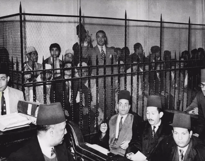 Cairo Rioters on Trial:The accused in a grilled dock during the trial. The tribunal building, near Cairo's famous citadel, was heavily guarded by police.Twenty men appeared before a military court in Cairo, March 12, in the first of a series of trials against more than 120 people accused of taking part in the January 26 Cairo riots and firemaking.The trials are to continue for several days.Six out of the 20 were tried March 12 for burning, looting and destroying the plaza cinema in Cairo's Shubra district. April 1, 1952. (Photo by Associated Press Photo).