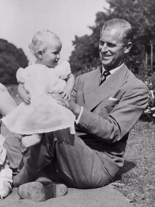 A Happy Family In Their Garden -- The Princess Anne bounces happily on her father's knee.Picture just released show H.R.H. Princess Elizabeth and the Duke of Edinburgh with their children Prince Charles and Princess Anne in the garden of the London Home Clarence House. August 09, 1951. (Photo by Barratts Photo-Press-Agency)