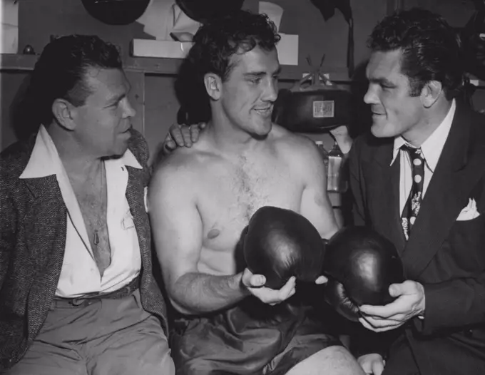 When Fishers Meet - Billy Conn (center), chats with middleweight Mickey Walker (left), and Freddie Mills (right), British light heavyweight champion, in a dressing room at his training camp in Greenwood Lake, N.J., June 12, where he is in training for his forthcoming bout, June 19, with Joe Louis. June 12, 1946. (Photo by Associated Press Photo).