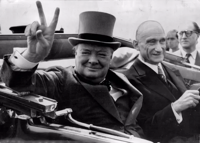 Churchill In V-Humour In Metz -- Mr. Winstons Churchill Ex-Premier, gives his "V" sign as he drives through world famous "V" sign as he drives through cheering inhabitants of the French Town of Metz  on the way to a civil banquet. With him is M. Robert Schuman, French Minister of Finance. July 16, 1946. (Photo by Associated Press Photo).