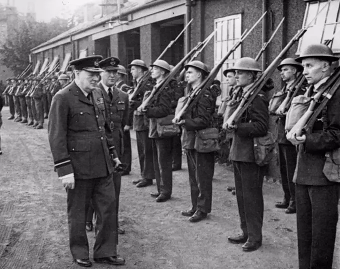 Air Commodore Churchill -- Inspected a R.A.F. guard of honour at the aerodrome.The Prime Minister wearing the uniform of Air Commodore of the Royal Air Force recently visited No. 615 Squadron of which he is honorary air commodore. He spent some time looking round the aerodrome and had tea with officers in the Mess. He was accompanied by Mrs. Churchill. September 30, 1941. (Photo by British Official Photograph).