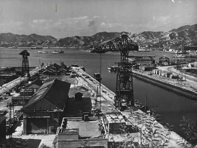 Kure Harbour, Japan -- One of the Japan's former key naval bases are at present base of all British forces in Japan. Land seen in the distance is Hiroshima prefecture. July 1, 1953. (Photo by Camera Press).