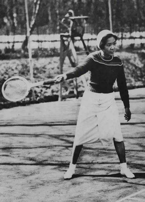 The Queen Of Siam As Tennis Star -- The Queen of Siam indulging in a game of tennis.The King and Queen of Siam, now visiting Paris, are both great sport lovers. While the King was having a round of golf, the Queen on a nearby court, was indulging in her favourite game of tennis. May 21, 1934. (Photo by Associated Press Photo).