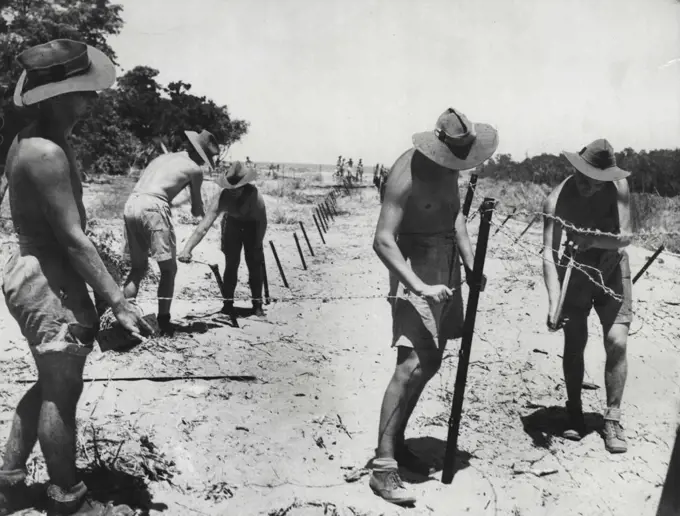 Diggers carry out a dull, tough but vital job in harsh conditions.Our forces in around Darwin working in extreme heat are fixing mules of ***** war defences. January 02, 1942.