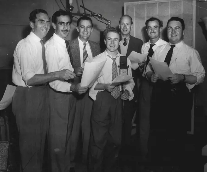 Cast of Biggles at the recording of the 1000th episode of the popular serial. From left: Frank Waters, Walter Sullivan (Bertie), Leonard Bullen, John Ewart, James Mills (Biggles), Max Osbiston and Kevin Brennan. Serial produced the AWA Studios by J. Colin Craigen is heard nightly on 2CH at 6.0. May 01, 1953. (Photo by Gervaise Purcell ).