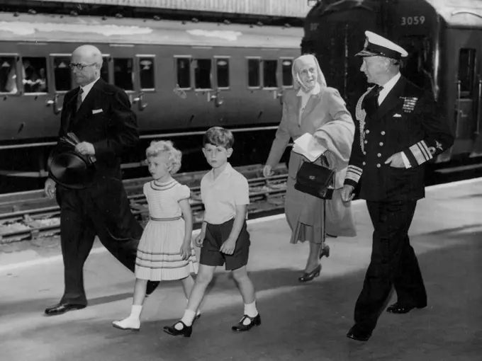 Royal Children Arrive At Portsmouth -- Prince Charles and his sister, Prince Anne, followed by their grandmother, Princess Andrew of Greece, and accompanied by Vice-Admiral Conolly Abel Smith, Flag officer Royal Yachts, and Stationmaster Mr. T. Fryer, walk from the train on arrival at Portsmouth to-day (Friday) from London to embark in the Royal yacht Britannia.They are to join their parents, the Queen and Duke of Edinburgh, on an eight-day cruise, during which the Royal couple will fulfill engagements in Wales, the Isle of Man, and Scotland. August 05, 1955.