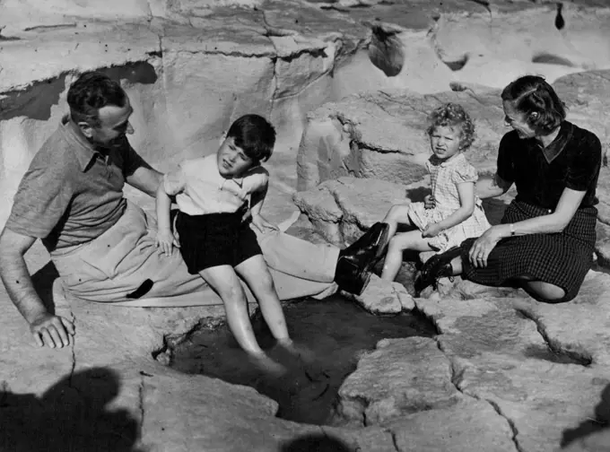 Earl Mountbatten - "Uncle Louis" -- lends steadying hand as Prince Charles probes a tempting paddling pool. Lady Mountbatten looks after Princess Anne.Eight days out from Britain on their way to join their parents in North Africa Prince Charles and Princess Anne went ashore at Malta for a picnic and a paddle among the rocky coves of the island. April 26, 1954. (Photo by Daily Mirror).