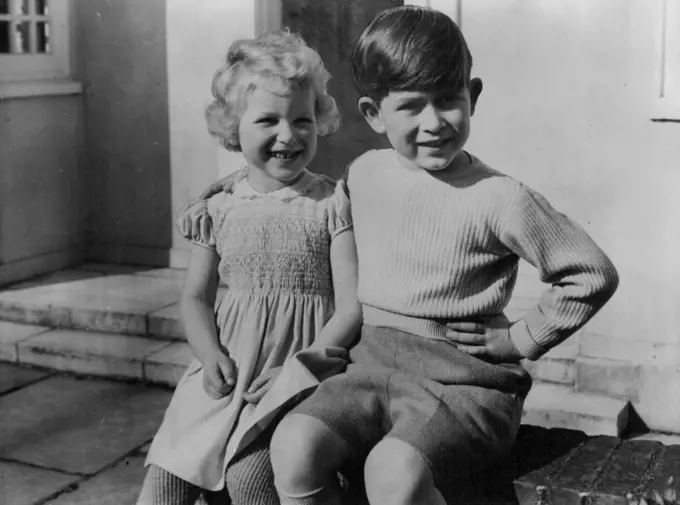 Royal Children At Windsor Lodge -- Hitherto unpublished picture of the Royal Children, Prince Charles and Princess Anne, photographed as they sit together on the low wall of the little Welsh House at Royal Lodge, Windsor. August 18, 1954. (Photo by Paul Popper, Paul Popper Ltd.).