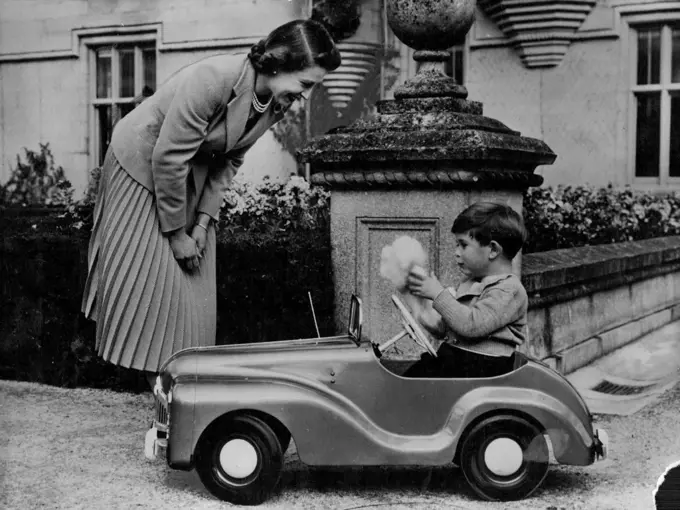 Prince Charles Is Four Today :This delightful mother and child study shows the Queen watching Prince Charles play with a glove puppet in his toy car in the grounds of Balmoral Castle.It was made specially to commemorate Prince Charles' Fourth Birthday Anniversary on November 14.This is the pedal car that is Prince Charles' greatest delight. The car is not elaborate, but has lights and a dummy radio mast. December 24, 1952. (Photo by Associated Press Photo).