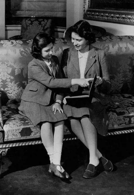 The British Royal Family -- The two girls sitting on this couch are Princess Elizabeth , heir to the throne of England, and her sister Princess Margaret Rose. They are sitting in Buckingham Palace, reading a book.Already, Princess Elizabeth is emerging from the schoolroom into public life, for not long ago she celebrated her sixteenth birthday by inspecting the Grenadier guards, of which she is Colonel-in-Chief, by making her first public speech.No sovereigns for at least a hundred and fifty years have sat on the throne of England in more and ***** times than the parent of these two girls.Kind George VI and Queen Elizabeth must friend much comfort in these two happy children. September 14, 1942. (Photo by Fox Photos Ltd.)