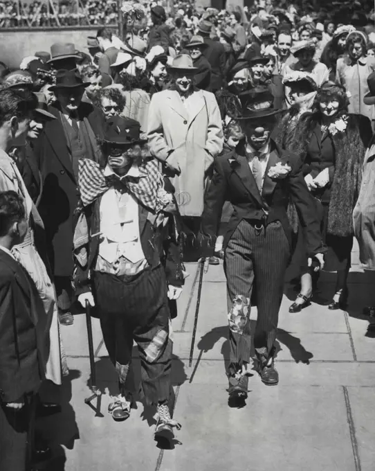 'Gentlemen Of The Road' In Easter 'Finery' -- Just to be a lot different from the parading thousands in all their Easter Sunday finery, George Savage (left) and Tom O'Donnell join throng in Rockefeller plaza, New York, grabed in the comic strip version of the well-dressed hobo wears. It was all in fun and fun for all, to judge from expressions of the spectators. April 17, 1949. (Photo by Associated Press Photo).
