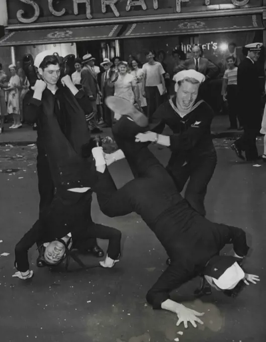 Broadway Capers -- Four sailors contributed these antics for the amusement of the many people awaiting news of the Japanese surrender in New York’s Times Square, August 14. August 14, 1945. (Photo by Associated Press Photo).