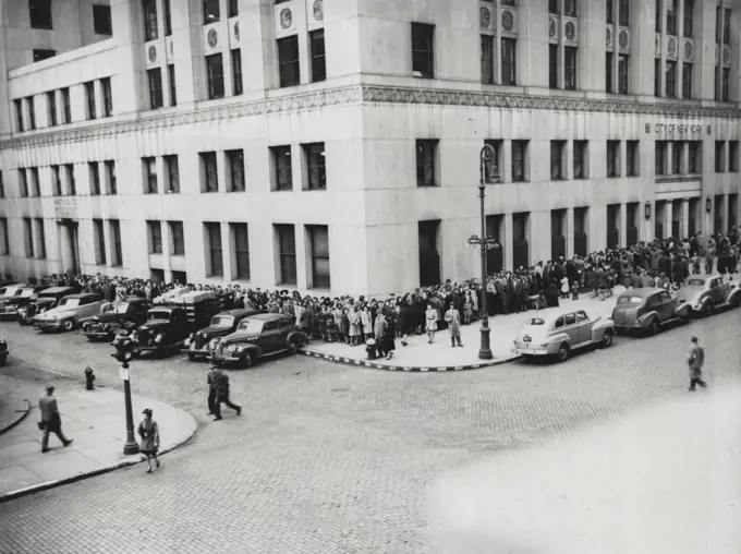 Waiting For Vaccinations -- Crowds line the sidewalk leading to entrance of the Health Department Building, New York City, April 14, as they wait their turn to receive smallpox vaccinations in response to Health Commissioner Israel Veinstein's Radio Plea that the public be vaccinated after nine cases, including two facilities,were reported. April 14, 1947. (Photo by Associated Press Photo).