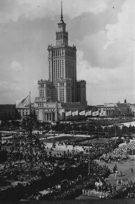 World Festival Of Youth - In Warsaw -- The parade competitors and national representatives in the Stalin Square, with the striking Palace of Culture and knowledge in the background.Thousands of visitors from many parts of the world attended the World Festival of Youth devoted to culture and sport - held in Warsaw, Poland. August 18, 1955. (Photo by Sport & General Press Agency, Limited).