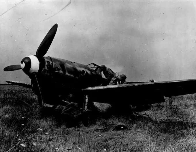 Fighter Plans Abandoned By Retreating Nazis -- American soldiers examine a German FW-190 fighter plane left behind by Germans fleeing from the Nogent-le-Roi sector in Franco. The American advance in this area was so overwhelming and swift that the Nazis had no time to take the plane with them. This picture has just been released by the consors. January 1, 1945. (Photo by U.S. Signal Corps Photo).