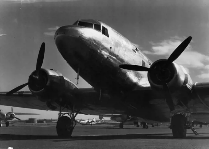 D.C.3 aircraft at Mascot prior to departure on first flight of Sydney-New Gunea service. April 2, 1945. (Photo by Richard McKinney, Qantas Empire Airways Limited).