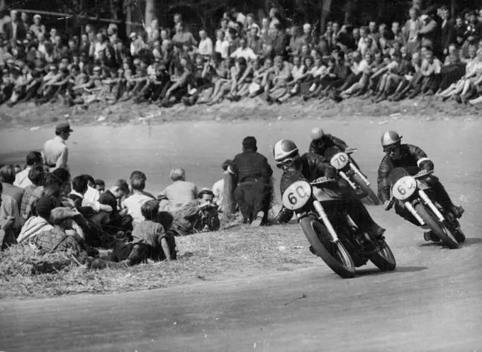 Duke wins in Germany - In the 350 cc event Geoffrey Duke (60) leads Johnny Lockett (65), of Britain who was second, and Ken Kavanagh of Australia (70) who was third. All are driving British Norton machines.British Geoffrey Duke set two new track records at the ***** race course near Stuttgart, August 26, when he won both the major events of the German motor-cycle Grand Prix. He won the 500 cc event at an average of 136 kmph (about 84.5 mph) and the 350 cc event at 130.6 kmph (about 81 mph). September 8, 1951.