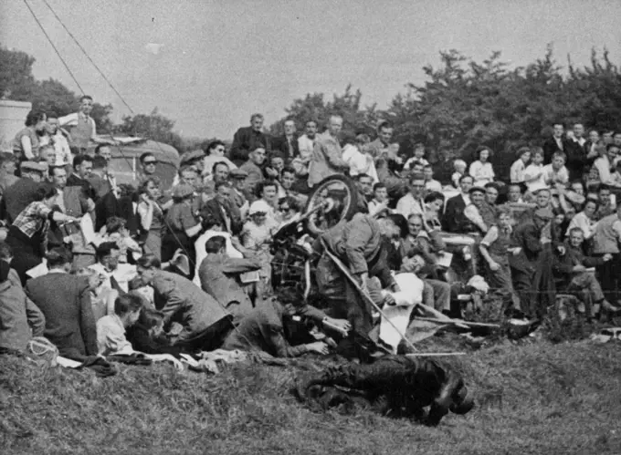 Motorcyclist Crashed into SpectatorsThe scene as A.R. Verity, riding an A.J.S., skidded into the crowd at coal hole corner during the Ulster Grand Prix over the Clady circuit in county Antrim, Northern Ireland, Aug 16. Verity is seen on the ground with his bike crashing into the crowed and a flag marshal being struck. None of the spectators was seriously injured. Verity was taken to hospital but released after treatment. September 03, 1952. (Photo by Associated Press Photo).