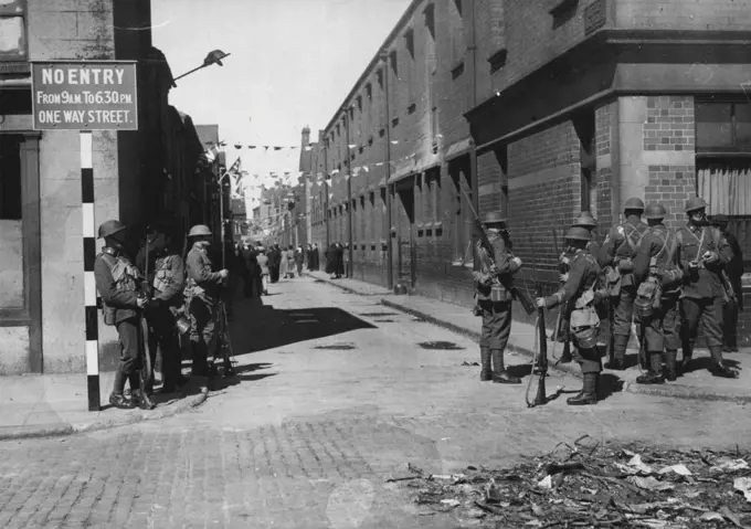 The Belfast Riots -- Troops on guard with fixed bayonets in York Street - the seat of the trouble - in Belfast today, July 14.Troops were called out in Belfast last night, July 13, when rioting between unionists and Nationalists, high began on Friday, flared up again. July 14, 1935. (Photo by Associated Press Photo).