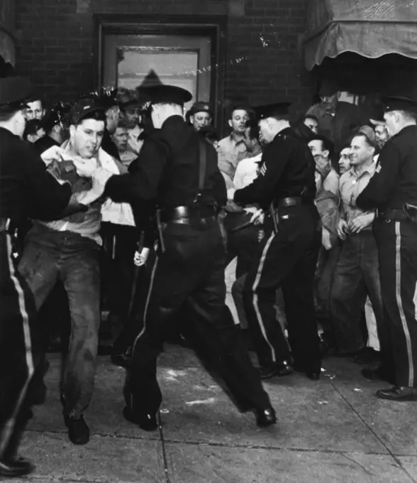 Scuffle: Police scuffle with pickets before offices of the American Marsh Pump Co., here yesterday. Pickets had set up a blockade to prevent office workers form entering the strikebound plant. July 23, 1946. (Photo by AP Wirephoto).