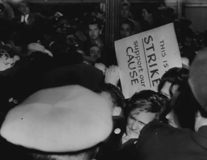 Scuffle On The Picket Line -- Police, AFL unionists and spectators scuffle in front of Hasting's store here today in first abortive violence in the AFL protest walkout. Note expression on bus driver (lower right center) as police move in to quell disturbance. December 3, 1946. (Photo by AP Wirephoto).