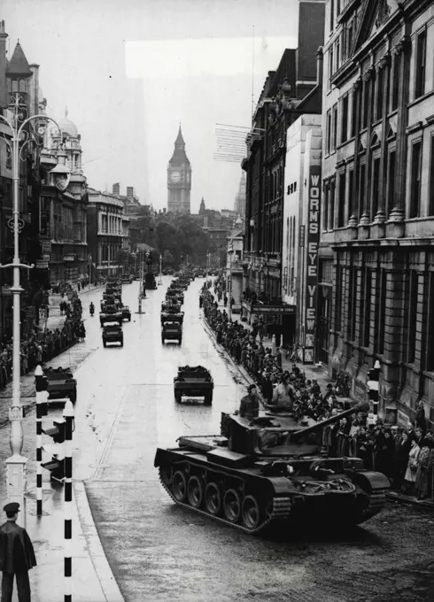 London Sees Victory Parade Rehearsal -- The early morning crowd watching the mechanised procession coming up Whitehall into Trafalgar Square. In the background rises the tower of Big Ben.Londoners turned out early on the Sunday preceding Victory Day to watch a full dress rehearsal of the mechanised part of the Victory Parade. June 02, 1946.