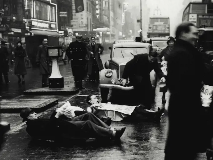 Unemployed Men Lie Down in Oxford Street -- The unemployed men lying in the road at the corner of Oxford Street and Berwick Street.Members of the Unemployed Workers Movement staged another demonstration today when they laid down in the road at the corner of Oxford Street and Berwick Street, Holding up the traffic until the police dispersed them. January 17, 1939. (Photo by Keystone Press Agency Ltd.).