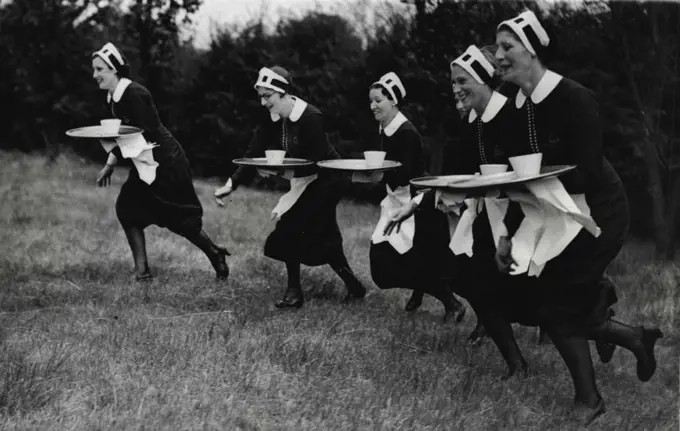 Sports Carnival At Sudbury.Waitresses carrying plays during the "Nippies" race. August 30, 1937. (Photo by Keystone).