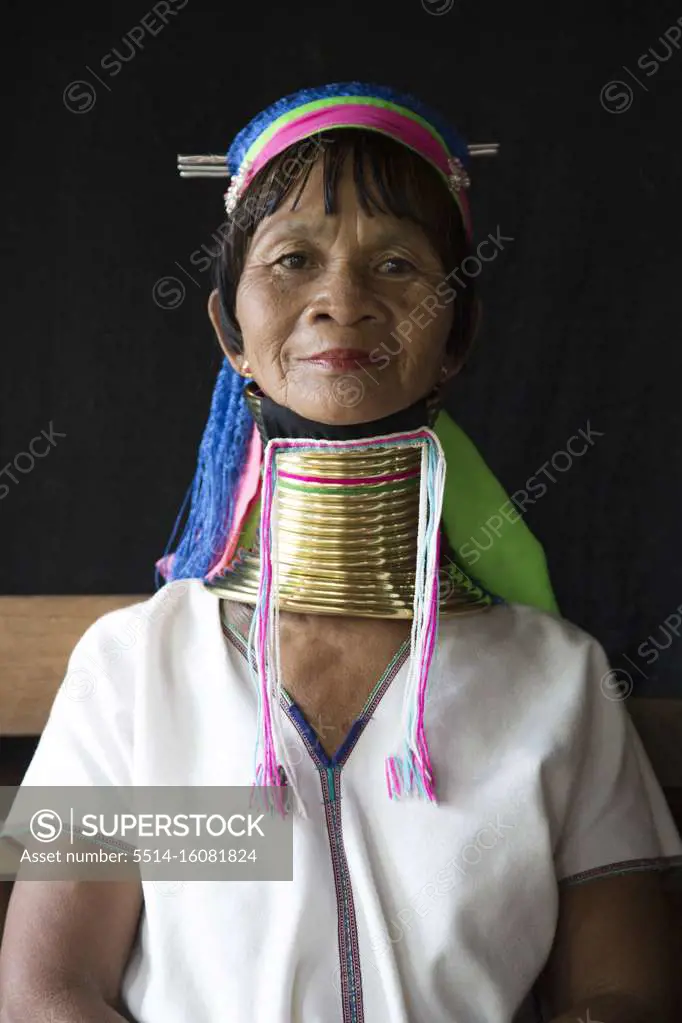 One woman from the long neck tribe with black background, Inle Lake