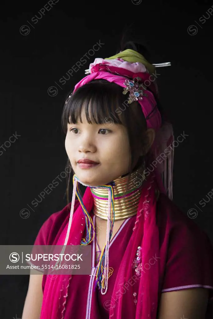Young woman from the long neck tribe with black background, Inle Lake