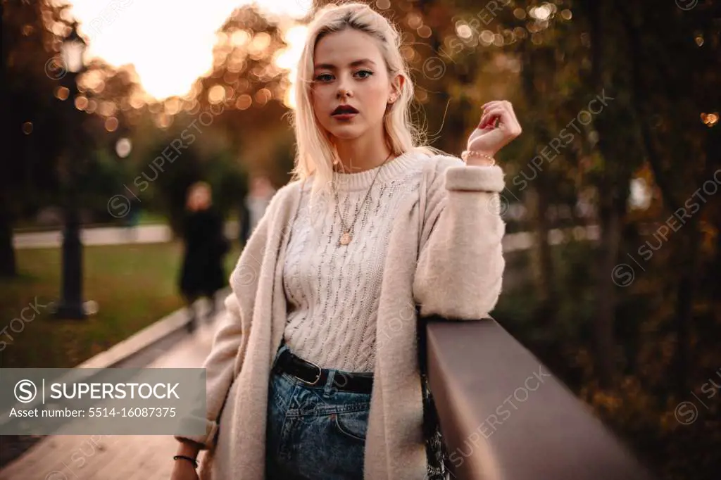 Portrait of confident young woman standing in park during autumn
