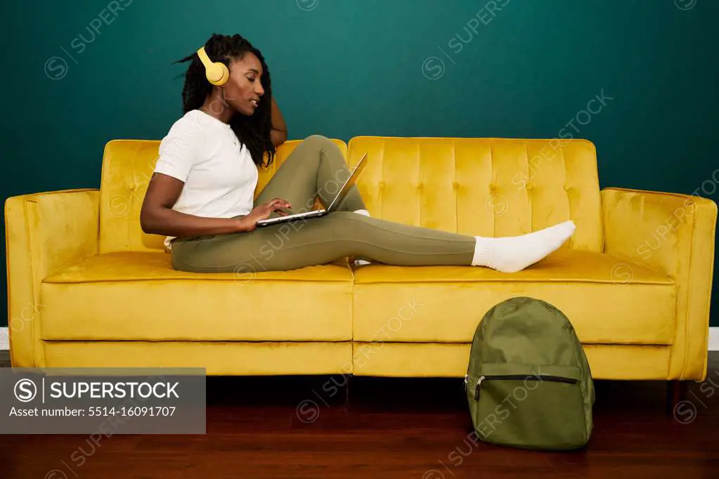 Black styled student woman having a videoconference at the coach